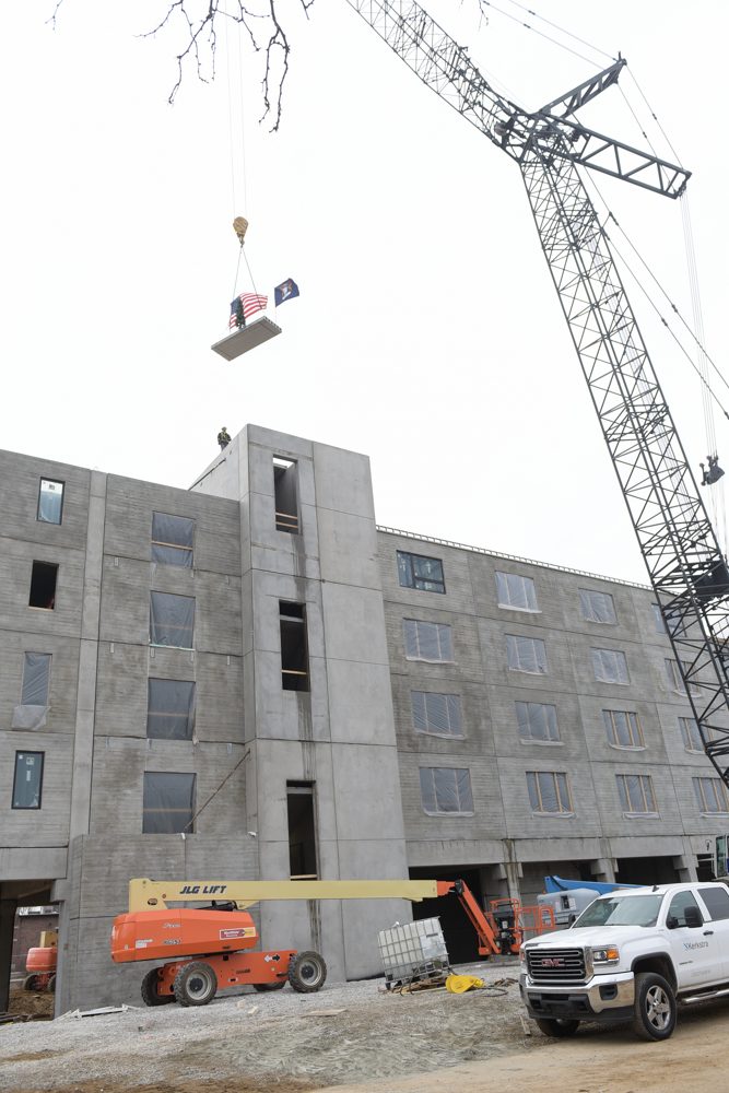 Harrison Circle, crane setting a panel atop the rising structure