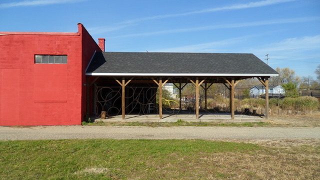 The Ignertia Building, red brick exterior with covered wood pavilion