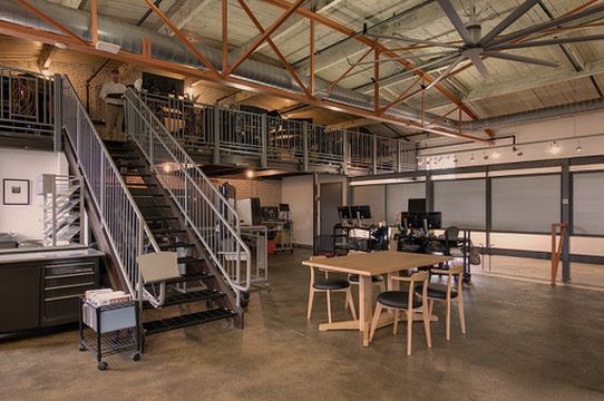 The Ignertia Building, loft dining and office area beneath steel trusses